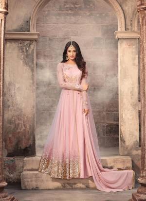 Dolled Up With This Very Pretty Baby Pink Colored Designer Floor Length Suit Paired With Baby Pink Colored Bottom And Dupatta. Its Top Is Fabricated On Net Paired With Santoon Bottom And Chiffon Dupatta. This Pretty Color Will Definitely Earn You Lots Of Compliments From Onlookers.