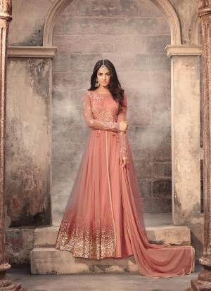 Grab This Suit For The Next Wedding You Attend n Very Pretty Peach colored Designer Floor Length Top Paired With Peach Colored Bottom And Dupatta. Its Top Is Fabricated On Net Paired With Santoon Bottom And Chiffon Dupatta. Buy It Now.