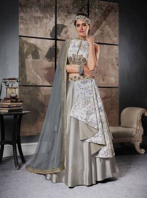 Here Is A Designer Lehenga Choli In Grey Color With Different Cuts And Drapes. Its Lehenga, Blouse Are Dupatta All Are In Grey Color. Its Blouse Is Fabricated On Art Silk Paired With Art Silk And Jacquard Silk Lehenga With Net Dupatta. Its Rich Color Will Definitely Earn You Lots Of Compliments From Onlookers.