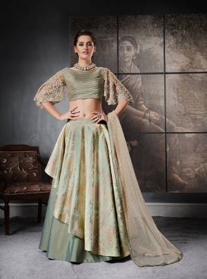 A Perfect Designer Piece Is Here With This Designer Lehenga Choli In Mint Green Color Paired With Beige Colored Dupatta. Its Blouse Is Fabricated On Art Silk And Net Paired With Art Silk And Jacquard Silk Lehenga With Net Fabricated Dupatta. Its Attractive Sleeves And Unique Pattern Will Give Your Personality A Look Like Never Before.