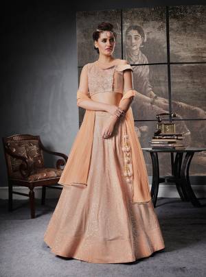 Most Demanding Color Of The Season Is Here With This Pretty Peach Colored Lehenga Choli Paired With Peach Colored Dupatta. This Designer Lehenga Choli Is Suitable For All Occasion Wear. Buy This Now.