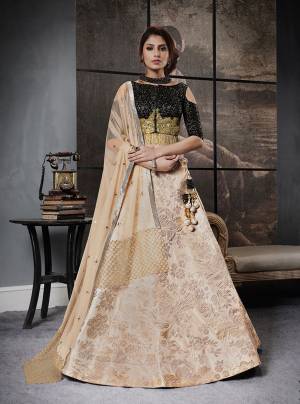 For A Trendy Look, Grab This Beautiful Designer Lehenga Choli In Black Colored Blouse Paired With Beige Colored Lehenga And Dupatta. Its Blouse Is Fabricated On Art Silk Paired With Jacquard Silk Lehenga And Net Dupatta. Wear This And You Will Definetly Catch All The Lime Light.