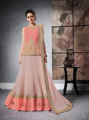 Look Lovely Wearing This Designer Lehenga Choli In Peach Colored Blouse Paired With Contrasting Baby Pink Colored Lehenga And Dupatta. Its Blouse Is Fabricated On Art Silk Paired With Lycra Net Lehenga And Lycra Net Dupatta. It Has Attractive Embroidery Over The Blouse And Dupatta Lace Border. Buy It Now.