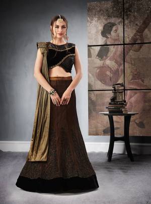 Dark Colors Compliments Every Skin Tone, So Grab This Designer Lehenga Choli In Black Colored Blouse Paired With Brown Colored Lehenga And Copper Colored Dupatta. Its all Three Colors Will Give An Attractive Look To Your Personality. Buy This Lehenga Choli Now.