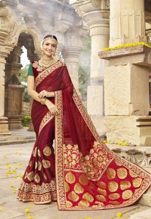 Feel Like A Queen Wearing This Designer Saree In Maroon Color Paired With Maroon And Green Colored Blouse. This Saree Is Fabricated On Satin Silk Paired With Art Silk Fabricated Blouse. Buy This Royal Looking Saree Now.