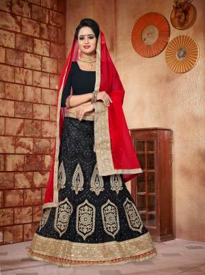 Enhance Your Beauty Wearing This Designer Lehenga Choli In Black Color Paired With Contrasting Red Colored Dupatta. Its Blouse Is Fabricated On Art Silk Paired With Net Lehenga And Georgette Dupatta. It Has Detailed Resham And Jari Embroidery With Stone Work.  
