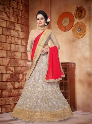 Simple And Elegant Looking Designer Lehenga Choli Is Here In Beige Color Paired With Contrasting Red Colored Dupatta. Its Blouse Is Fabicated On Art Silk Paired With Georgette Fabricated Lehenga And Dupatta. It Has Heavy Attractive Embroidery All Over It.