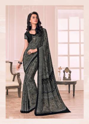 Enhance Your Beauty Wearing this Saree In Dark Grey Color Paired With Black Colored Blouse. This Saree And Blouse Are Fabricated On Crepe Beautified With Intricate Prints All Over. Buy This Saree Now.