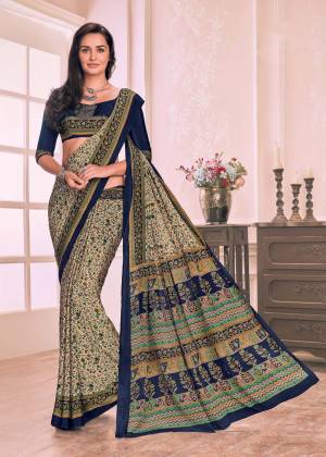 Flaunt Your Rich And Elegant Taste Wearing This Saree In Cream Color Paired With Contrasting Navy Blue Colored Blouse. This Saree And Blouse Are Fabricated On Crepe Beautified With Small Floral Prints.