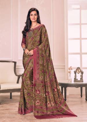 New And Unique Shade Is Here With This Saree In Olive Green Color Paired With Contrasting Wine Colored Blouse. This Saree And Blouse Are Fabricated On Crepe Beautified With Floral Prints All Over It.