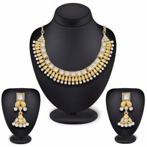 Simple And Elegant Necklace Set Is Here In Golden Color Beautified With White Colored Stones And Pearl. This Necklace Set Is Light Weight And Can Be Paired With Any Attire Like Kurti, Suit, Saree Or Lehenga. Buy Now.