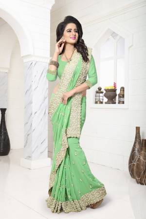 Get Ready For the Next Wedding With This Lovely Saree In Light Green Color Paired With Light Green Colored Bottom And Dupatta. This Saree And Blouse Are Fabricated On Georgette. It Will Definetly Earn You Lots Of Compliments From Onlookers As It Has Heavy Moti Work.
