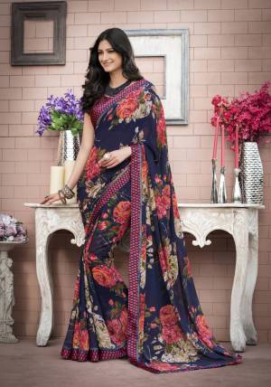 Grab This Saree In Navy Blue Color Paired With Navy Blue And Pink Colored Blouse. This Saree Is Fabricated On Georgette Beautified With Bold Floral Prints All Over The Saree. Buy This Lovely Saree Now.