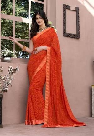 Shine Bright Wearing This Saree In Orange Color Paired With Orange Colored Blouse. This Saree Is Fabricated On Georgette Paired With Satin Fabricated Blouse. This Attractive Saree And Blouse Are Beautified With Prints. It Is Light Weight And Easy To Carry All Day Long.