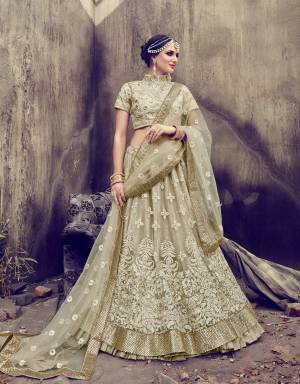 Flaunt Your Rich And Elegant Taste Wearing This Designer Lehenga Choli In Off-White Color Paired With Off-White Colored Bottom And Dupatta. Its Blouse Is Fabricated On Art Silk Paired With Georgette And Net Lehenga And Net Dupatta. It Has Heavy Embroidery All Over It. Wear This At Your Sibling's Wedding And Earn Lots Of Compliments From Onlookers.