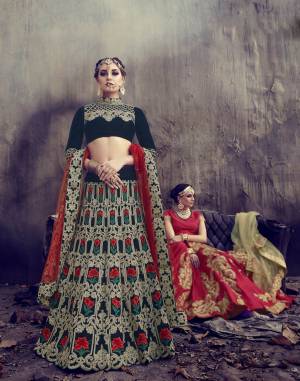 Enhance Your Beauty Wearing This Designer Lehenga Choli In Navy Blue Color Paired With Contrasting Red Colored Dupatta. Its Blouse And Lehenga Are Fabricated On Velvet Paired With Net Dupatta. It Has Heavy Embroidery All Over The Lehenga And Blouse And Dupatta. Buy It Now.