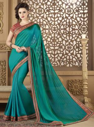 An Elegant Designer Look Is Here With This Saree In Blue Color Paired With Contrasting Red Colored Blouse. This Saree Is Fabricated On Soft Silk Paired With Art Silk Fabricated Blouse. It Has Heavy Embroidered Blouse With Embroidered Lace Border.