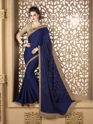 For A Rich Personality, Grab This Designer Saree In Navy Blue Color Paired With Beige Colored Blouse. This Is Fabricated On Soft Silk paired With Net Fabricated Blouse. It Is Beautified With Heavy Embroidred Lace Border And Blouse Which Is Giving An Attractive Look To The Saree.
