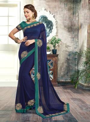 Enhance Your Personality Wearing This Saree In Navy Blue Color Paired With Contrasting Teal Green Colored Blouse. This Saree Is fabricated On Georgette paired With Art Silk Fabricated Blouse. It Is Light Weight, Easy To Drape And Carry All Day Long.