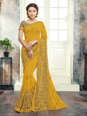 Celebrate This Festive Season With Such Lovely Colored Saree In Yellow Paired With Beige Colored Blouse. This Saree Is Fabricated On Georgette Paired With Art Silk Fabricated Blouse. Its Color And Fabric Will Earn You Lots Of Compliments From Onlookers.