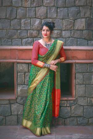 Here Is A Proper Traditonal Colored Saree In Green Color Paired With Contrasting Red Colored Blouse. This Saree And Blouse Are Fabricated On Jacquard Silk Beautifid With Weave. Buy this Saree Now.