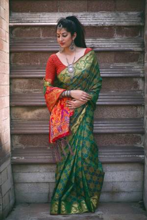 Celebratr this Festive Seaosn Wearing This Saree In Dark Green Color Paired With Contrasting Red Colored Blouse. This Saree And Blouse Are Fabricated On Jacquard Silk Beautified With Weave All Over It. Its Color Combination Will Make you Look The Most Attractive Of All.