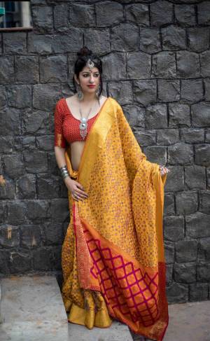 This Festive Season, Grab This Beautiful Traditional Saree In Yellow Color Paired With Orange Colored Blouse. This Saree And Blouse Are Fabricated On Jacquard Silk Beautified With Weave All Over It. This Saree Is Easy To Drape And Also Durable.