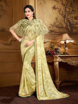 Simple And Elegant Looking Saree Is Here In Cream Color Paired With Dark Green Colored Blouse Cream Colored Cape. This Saree Is Fabricated On Georgette Brasso Paired With Crepe Fabricated Blouse And Net Cape. This Saree Ensures Superb Comfort All Day Long. 