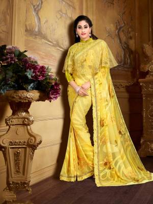 Celebrate This Festive Season Wearing This Designer Saree In Yellow Color Paied With Yellow Colored Blouse And Cape. This Saree Is Fabricated On Georgette Brasso Paired With Crepe Blouse And Embroidered Net Fabricated Cape. Buy This Designer Saree Now.