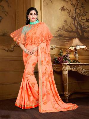 This Wedding Season, Flaunt Your Designer Taste Wearing This Cape Patterned Saree In Orange Color Paired With Contrasting Sea Green Colored Blouse And Orange Colored Cape. This Saree Is Fabricated On Georgette Brasso Paired with Crepe Fabricated Blouse And Net Fabricated Cape. This SAree Is Easy To Drape And Carry Throughout The Gala.