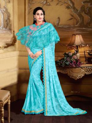 Earn Lots Of Compliments Wearing This Pretty Saree In Turquoise Blue Color Paired With Orange Colored Blouse And Turquoise Blue Colored Cape. This Saree Is Fabricated On Georgette Brasso Paired With Crepe Blouse And Net Fabricated Cape. This Pretty Saree Has Beautiful Embroidered Cape Which Wil Give An Outstanding Look To Your Personality.