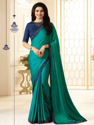 Grab This Pretty Party Wear Saree In Teal Green Color Paired With Contrasting Navy Blue Colored Blouse. This Saree Is Fabricated On Georgette Paired With Art Silk Fabricated Blouse. It Has Embroidery Over The Blouse And Saree Lace Border. Buy This Designer Saree Now.