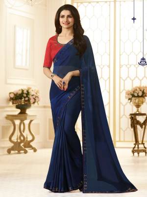 Contrasting Colors Always Left A Great Impact Over The Onlookers So Grab This Saree In Navy Blue Color Paired With Contrasting Red Colored Blouse. This Saree Is Fabricated On Georgette Paired With Art Silk Fabricated Blouse. Both Its Colors Are Pretty Attractive Which Will Earn You Lots Of Compliments From Onlookers.