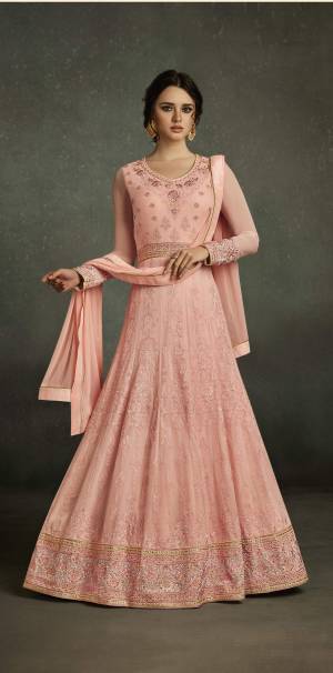 Most Demanding Color Of The Season Is Here With This Designer Floor Length Suit In Peach Color Paired With Peach Colored Bottom And Dupatta. Its Top Is Fabricated On Georgette With Heavy Embroidery Paired With Santoon Bottom And Chiffon Dupatta. This Designer Suit Will Give You A Pretty Doll Like Look. Buy This Suit Now.