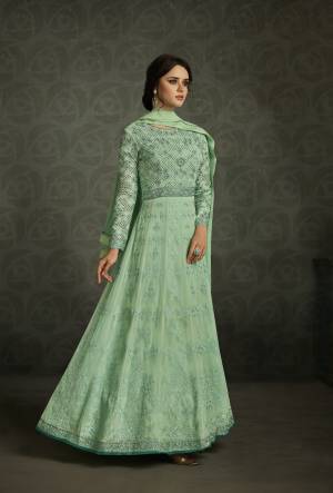 Here Is A Very Pretty Shade Of Green With This Designer Floor Length Suit In Sea Green Color Paired With Sea Green Colored Bottom And Dupatta. Its Top Is Fabricated On Georgette Paired With Santoon Bottom And Chiffon Dupatta. This Suit Is Beautified with Embroidery All Over It. Buy Now.