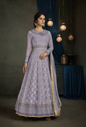 If Your Have An Eye For Colors, Than Grab This New And Pretty Shade Of Purple With This Designer Floor Length Suit In Lavendor Color Paired With Lavendor Colored Bottom And Dupatta. Its Top Is Fabricated On Georgette Paired With Santoon Bottom And Chiffon Dupatta. Its Colors And Detailing Will Definitely Earn You Lots Of Compliments From Onlookers. Buy Now.