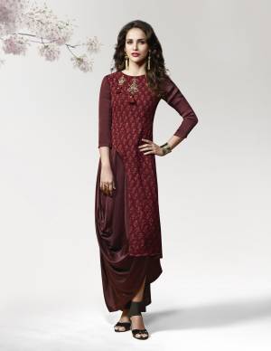 Here Is A Pretty Rich Looking Kurti In Maroon Color Fabricated On Crepe Silk Beautified With Prints And Patch Work. It Has An Attractive Drape Pattern Which Makes You Look The Prettiest Of All.
