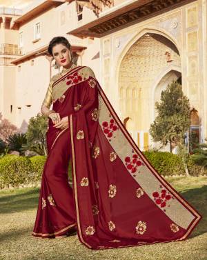 Be Like A Queen Wearing This Saree In Maroon Color Paired With Beige Colored Blouse. This Saree Is Fabricated On Silk Chiffon Paired With Brocade Fabricated Blouse. Its Attractive Lace Border Will Make You Look Attractive And Earn You Lots Of Compliments From Onlookers.