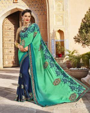 Add This Cool Colored Pallete Saree In Sea Green And Navy Blue Color Paired With Beige Colored Blouse. This Saree Is Fabricated On Georgette And Silk Paired With Brocade Fabricated Blouse. Its Lovely Combination Will Make You Look The Prettiest Of All.