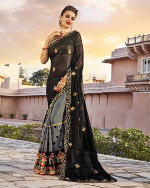 Enhance Your Beauty Wearing This Saree In Black And Grey Color Paired With Golden Colored Blouse. This Saree Is Fabricated On Georgette Paired With Brocade Fabricated Blouse. It Has Multi Colored Embroidery Which Gives an Attractive Look To The Saree.
