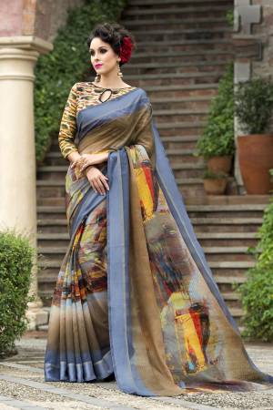 Flaunt Your Elegance Wearing This Saree In Light Brown And Blue Color Paired With Multi Colored Blouse. This Saree And Blouse Are Fabricated On Chanderi Silk Beautified With Multi Colored Prints. 