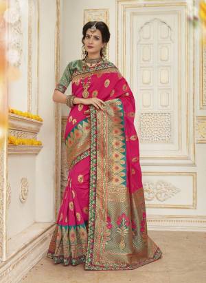 Attract All Wearing This Saree In Fuschia Pink Color Paired With Contrasting Green Colored Blouse. This Saree And Blouse Are Fabricated On Jacquard Silk Beautified With Weave And Embroidered Lace Border. Buy Now.