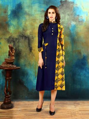 Here Is A Designer Patterned Readymade Kurti In Dark Blue And Yellow Color Fabricated Rayon Cotton Beautified With Prints. Its Fabric Ensures Superb Comfort All Day Long And It Is Easy To Care For.