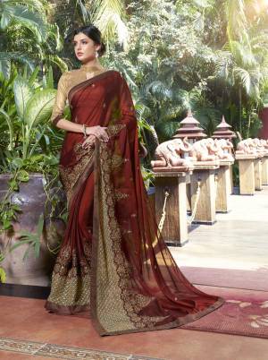 Here Is A Beautiful Queen Look With This Royal Saree In Maroon Color Paired With Beige Colored Blouse. This Saree Is Fabricated On Georgette Paired With Art Silk Fabricated Blouse. It Has Detailed Jari Embroidery Over The Saree Lace Border. Buy This Saree Now.