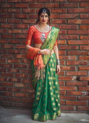For A Proper Traditonal Look, Grab This Saree In Green Color Paired With Contrasting Red Colored Blouse. This Saree And Blouse Are Fabricated On Banarasi Art Silk Beautified With Weave All Over It. This Saree Has A Proper Combination Of Traditon And Class. Buy Now.