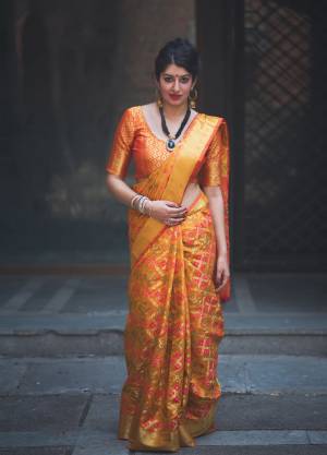 Add This Pretty Shade Of Yellow With This Trendy Saree In Musturd Yellow Color Paired With Contrasting Orange Colored Blouse. This Saree And Blouse Are Fabricated On Banarasi Art Silk Beautified With Weave All Over It. It Is Light Weight, Easy To Drape And Carry All Day Long.