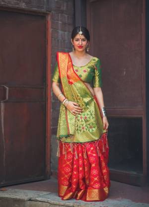 For A Proper Traditonal Look, Grab This Saree In Red Color Paired With Contrasting Green Colored Blouse. This Saree And Blouse Are Fabricated On Banarasi Art Silk Beautified With Weave All Over It. This Saree Has A Proper Combination Of Traditon And Class. Buy Now.