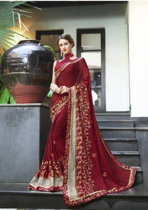 Royal Looking Saree Is Here With This Very Attractive Designer Saree In Maroon Color Paired With Maroon Colored Blouse. This Saree Is Fabricated On Georgette Paired With Art Silk Fabricated Blouse. It Has Attractive Embroidery Over Its Broad Border. Buy This Designer Saree Now.