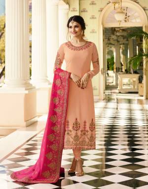 Most Demanding Color Of The Season Is Here With This Designer Straight Cut Suit In Peach Color Paired With Peach Colored Bottom And Contrasting Pink Colored Dupatta. Its Top Is Fabricated On Georgette Paired With Santoon Bottom And Crepe Dupatta. It Has Very Pretty Embroidery Over the Top And Dupatta Which Is Making The Suit Attractive.