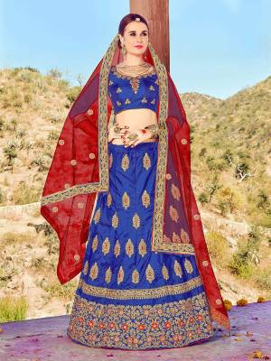 Here Is An Attractive Designer Lehenga Choli In Royal Blue Color Paired With Contrasting Red Colored Dupatta. Its Blouse And Lehenga Are Fabriacted On Art Silk Paired With Net Fabricated Dupatta. It Is Light Weight, Durable And Easy To Care For.